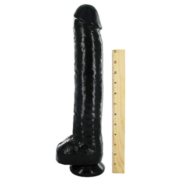 The Black Destroyer Huge Suction Cup Dildo next to ruler
